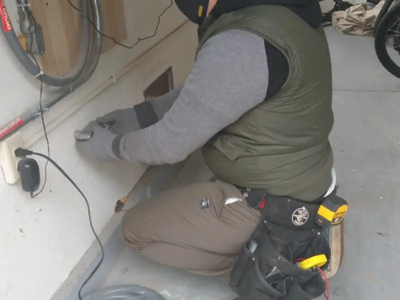 Electrician performing outlet wiring in a Issaquah garage